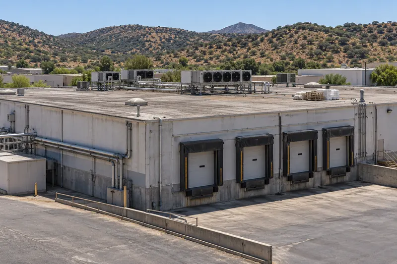 Produce cold-storage warehouse with truck docks and rooftop refrigeration units near Nogales