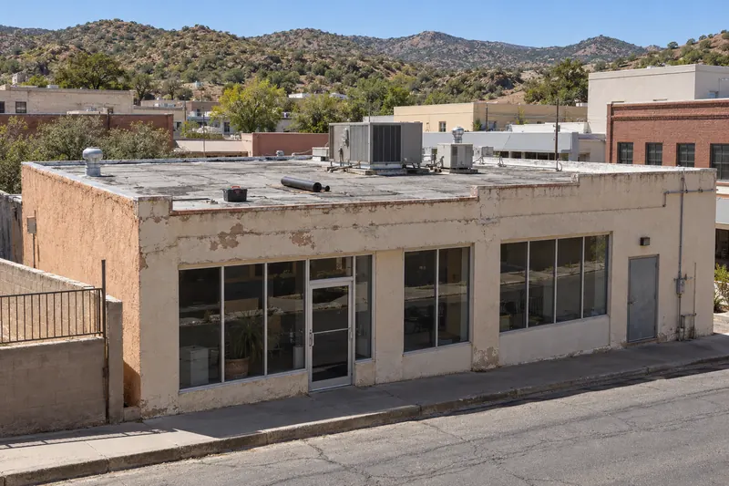 Older downtown commercial building with a flat roof and rooftop units in Nogales